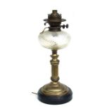 A Victorian oil lamp on brass column with glass reservoir, converted to electricity, 47cms high.