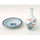 A Japanese bottle vase decorated with an exotic bird within prunus, two character blue mark to base,
