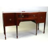 A 19th century mahogany breakfront sideboard with single central drawer flanked by two cupboards, on