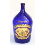 A Victorian style blue glass bottle - Penhaligan's Perfumers - approx 48cms high.