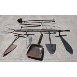 A quantity of bygone farming tools to include a malt shovel, hay fork, pitch fork and other