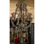 A Louis XVI style chandelier with glass drops.