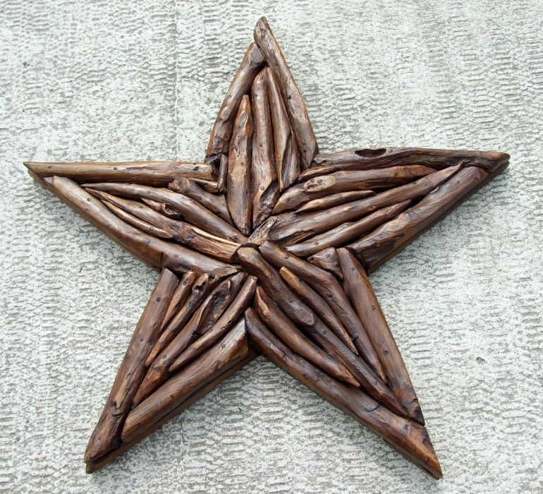 A driftwood decorative wall hanging in the form of a star, 86cms wide.