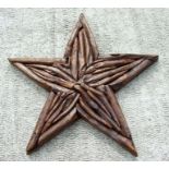 A driftwood decorative wall hanging in the form of a star, 86cms wide.