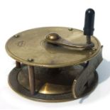 A late 19th / early 20th century A W Gamage brass fishing reel or winch, 7cms diameter.