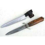 A Swedish MORA fighting knife with double edged blade, wooden handle in its metal scabbard with
