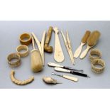 A group of ivory and bone items to include a parasol handle and glove stretchers.
