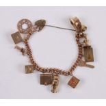 A 9ct gold charm bracelet with twelve charms, some articulated, weight 59g.