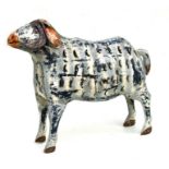 A large distressed painted metal sheep garden candle light. 64cm long