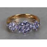 A 9ct gold and pale purple stone cluster ring, approx UK size 'J'.