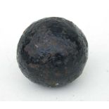 An 18th century cast iron solid cannon ball. Approximate diameter 12.5cms (5ins) approximate