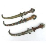 Three middle eastern Jambiya daggers in scabbards. Average overall length 40cms (15.75ins)