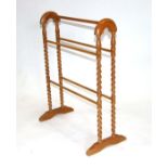 A beech towel rail with barleytwist supports.