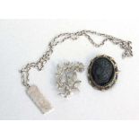 A modern silver ingot necklace, weight 32.8g; together with a cameo brooch and a marcasite floral