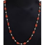 A 9ct gold pearl and coral necklace, 59cms long.