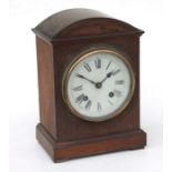 An Edwardian oak cased mantle clock, the white dial with Roman numerals, 29cms high.