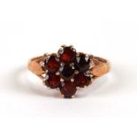 A 9ct gold and garnet cluster ring, weight, 3.3g, approx UK size 'P'.