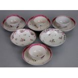 A set of four 18th century Newhall porcelain tea bowls and saucers decorated with flowers;