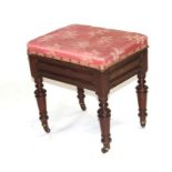 A Victorian mahogany piano stool with lift-up lid, on turned legs, 45cms wide.