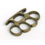 A WWI brass knuckle duster, 9cms wide.