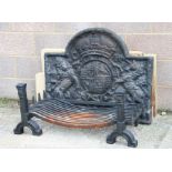 A 17th century style heavy cast iron arched top fire back with an armorial of rampant lion and