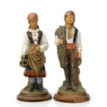 A pair of continental majolica figural match strikers, 20cms high (2).