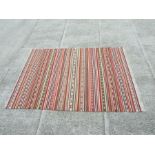 A flatweave rug, 141 by 200cms.