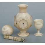 A carved ivory goblet, 7cms high; together with an ivory ball, stand and handle (4).