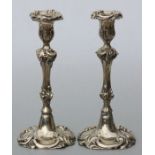 A pair of rococo design silver plated candlesticks, 26cms high (2).