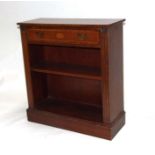 A reproduction mahogany open bookcase with single frieze drawer, 76cms wide.