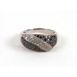 A 14ct white gold white and black diamond set dress ring, approx UK size 'R'.