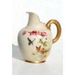 A Royal Worcester blush ivory milk jug decorated with butterflies and foliage, puce mark to the