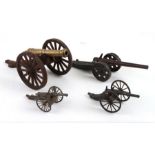 A miniature brass cannon mounted on a steel carriage, 31cms long; together with three similar