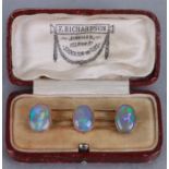 A Victorian 9ct gold (tested) bar brooch set with three opals, weight 6.2g, cased.