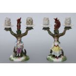 A pair of Meissen porcelain figural candelabra, each mounted with a figure and a squirrel, 23cms