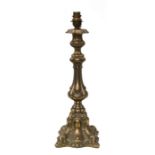 A brass rococo design table lamp, 39cms high.