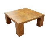 A contemporary mid century design burr walnut veneer coffee table with rectangular top on stout