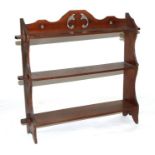 A late 19th century walnut three-tier wall shelves, 65cms wide.