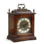 A George III style bracket clock, the silvered chapter ring with Roman numerals and fitted with a