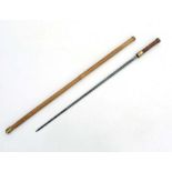 A cane swordstick with a triangular concave finely etched Spanish Toledo blade 65.5cms (25.75ins)