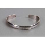 A Chinese silver bangle with floral engraved decoration, weight 37g.