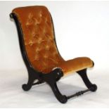 A Victorian ebonised slipper chair.