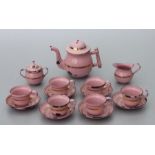 A vintage pink enamel and gilt doll's tea set.