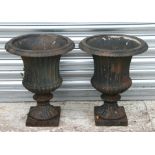 A pair of cast iron urns of classical form, 48cms high (2).