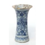 An early Delft trumpet vase decorated with flowers, 20cms high (a/f).