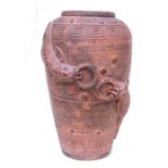 A large terracotta vase with moulded carved decoration, 60cms high.