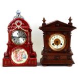 A mantle clock, the silvered dial with Roman numerals, in a ceramic case decorated with a