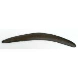 An aboriginal carved wooden boomerang, 56cms long.Condition ReportA few nicks to the edges,