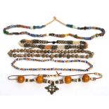 An African trade bead necklace; together with four similar necklaces (5).
