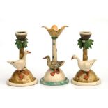 A pair of pottery candlesticks with applied geese by Anna Lambert, 20cms high; together with